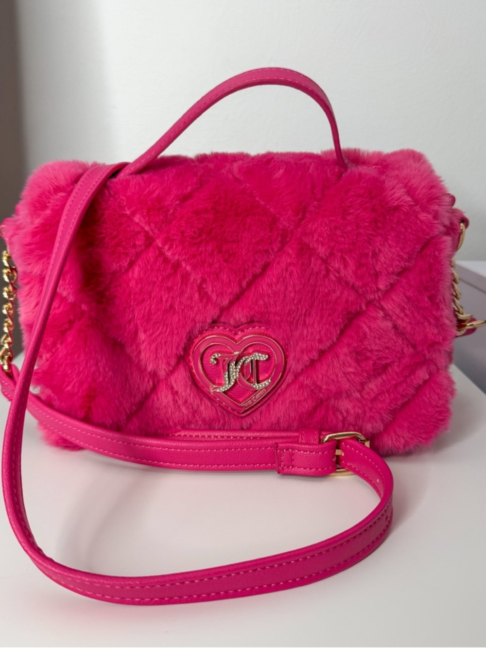 Juicy Couture Lets Get Cozy Crossbody Color: Pink Flash.